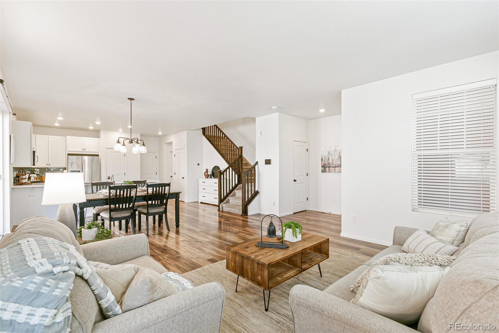 11159 East 25th Drive Aurora, CO 80010 - Photo 3 of 23 a living room with furniture and kitchen view