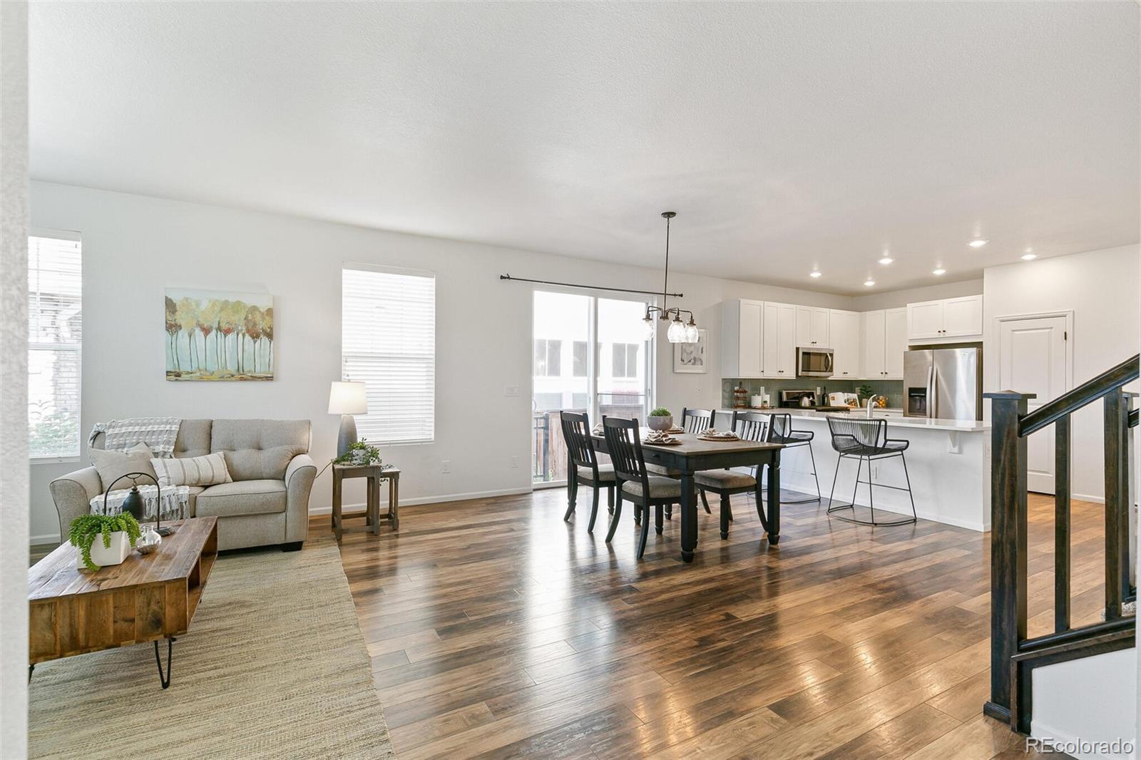 11159 East 25th Drive Aurora, CO 80010 - Photo 5 of 23 a view of a dining room with furniture window and wooden floor