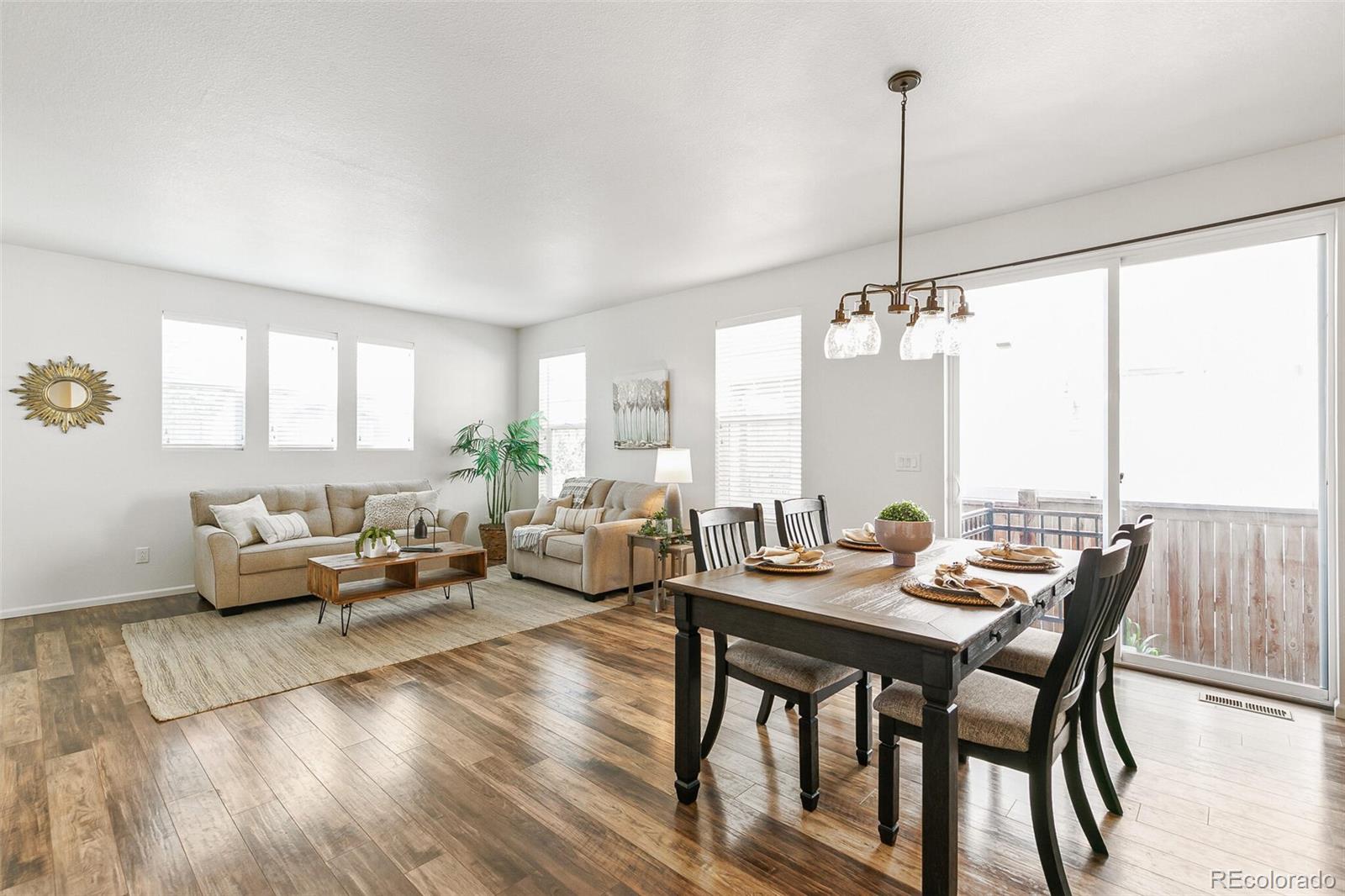 11159 East 25th Drive Aurora, CO 80010 - Photo 6 of 23 a living room with furniture and wooden floor