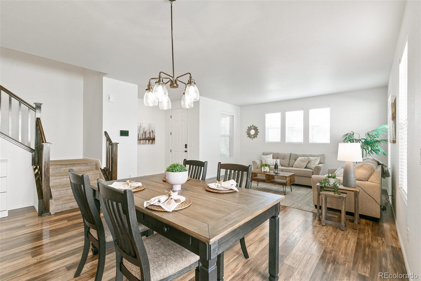 11159 East 25th Drive Aurora, CO 80010 - Photo 7 of 23 a view of a dining room with furniture and wooden floor