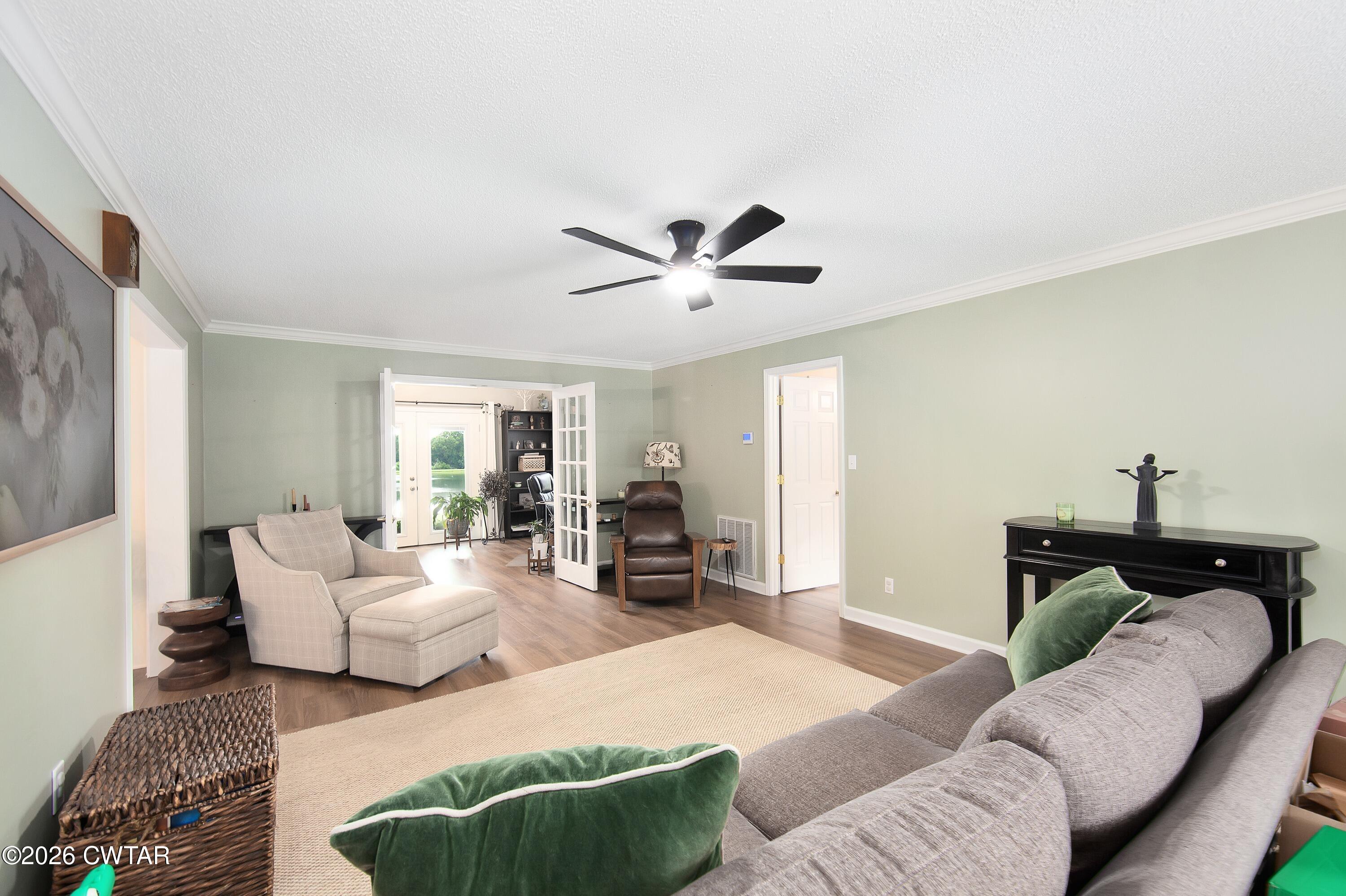 2757 Edward Williams Road Gadsden, TN 38337 - Photo 14 of 57 a living room with furniture ceiling fan and a rug