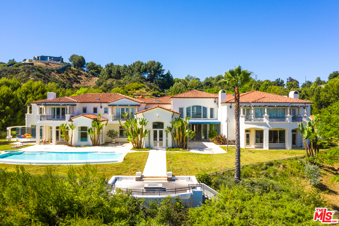 73 Beverly Park Lane Beverly Hills, CA 90210 - Photo 1 of 24 a front view of a building with a garden