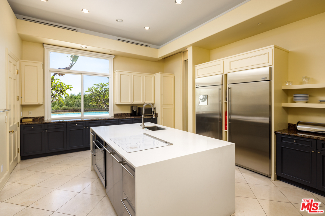 73 Beverly Park Lane Beverly Hills, CA 90210 - Photo 11 of 24 a kitchen that has a sink a refrigerator and a stove top oven