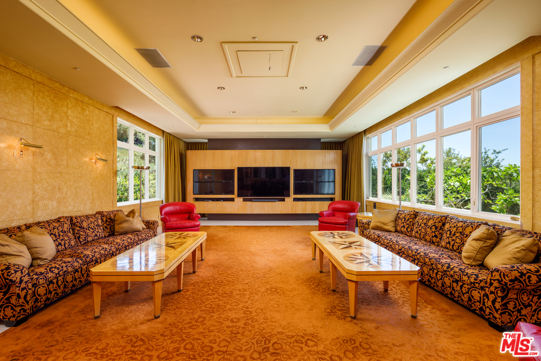 73 Beverly Park Lane Beverly Hills, CA 90210 - Photo 17 of 24 a living room with furniture and a large window