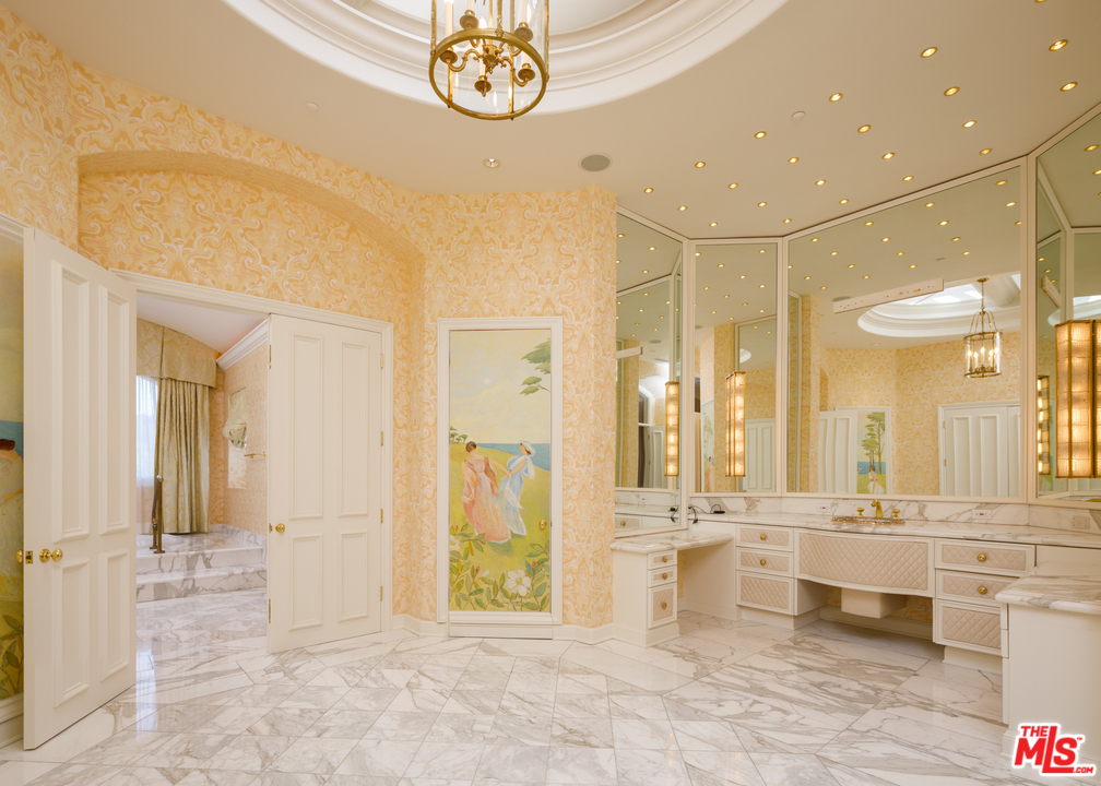 73 Beverly Park Lane Beverly Hills, CA 90210 - Photo 19 of 24 a view of a bathroom with a tub shower and sink