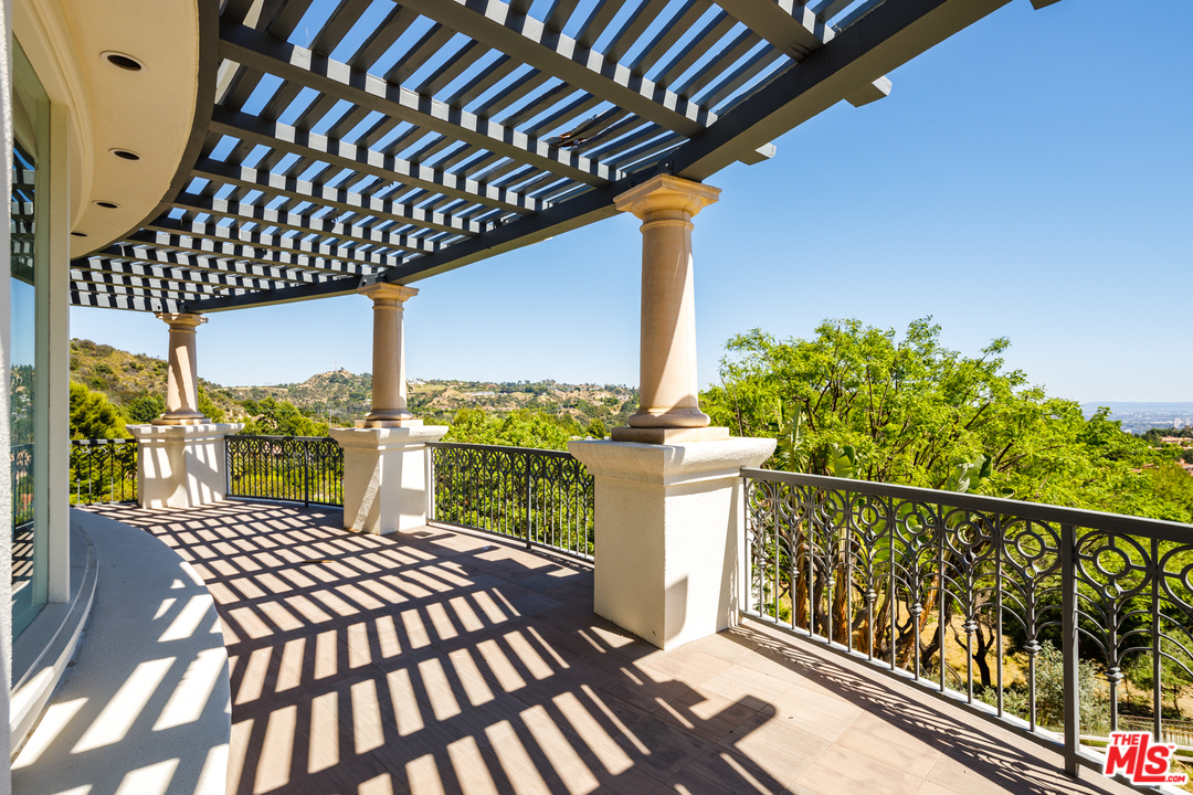 73 Beverly Park Lane Beverly Hills, CA 90210 - Photo 21 of 24 a view of a balcony with chairs