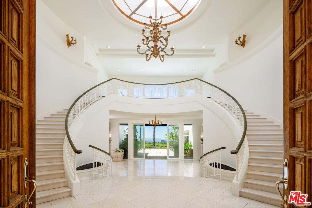 73 Beverly Park Lane Beverly Hills, CA 90210 - Photo 6 of 24 a view of a swimming pool with a balcony