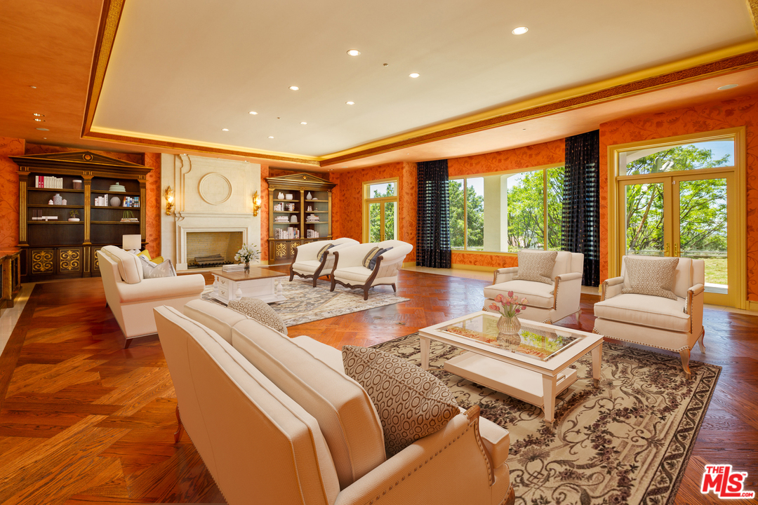 73 Beverly Park Lane Beverly Hills, CA 90210 - Photo 7 of 24 a living room with fireplace furniture and a large window
