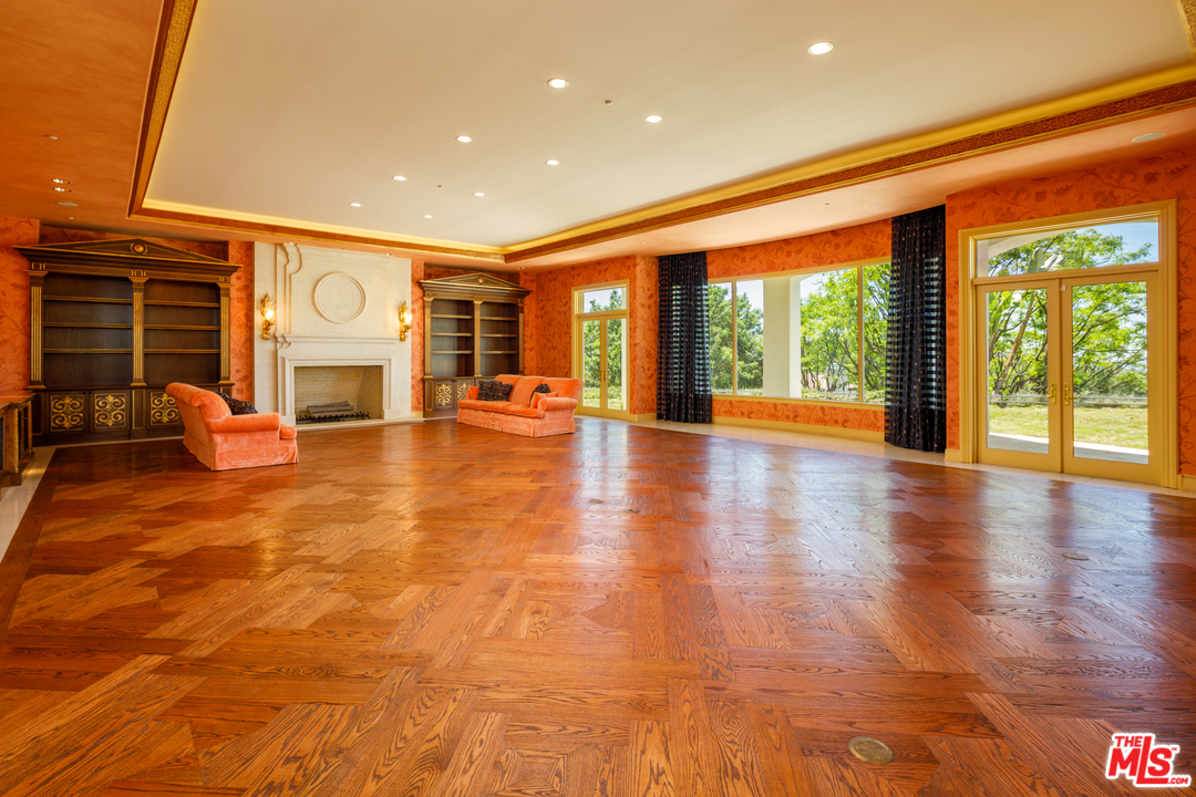 73 Beverly Park Lane Beverly Hills, CA 90210 - Photo 8 of 24 a view of a hall way with furniture and floor to ceiling window
