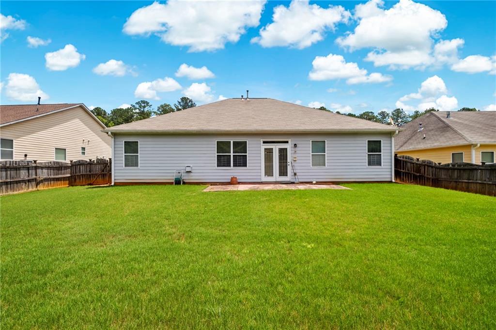 Undisclosed Address Atlanta, GA 30331 - Photo 20 of 25 a front view of a house with a garden and plants