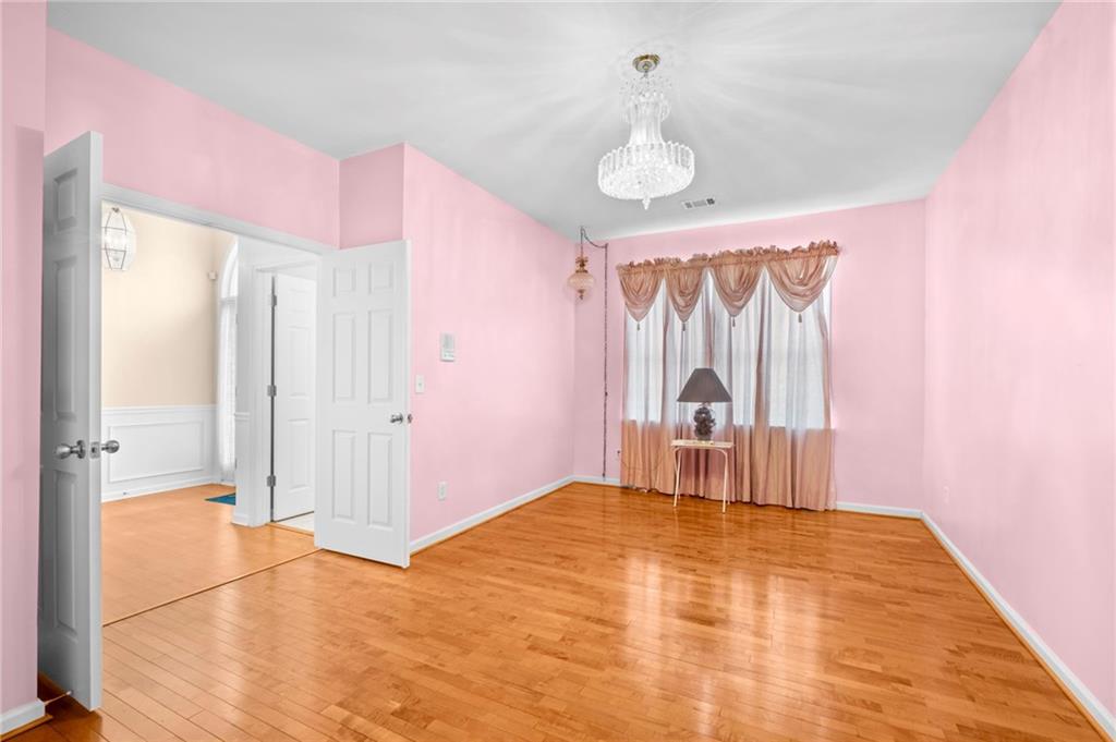 Undisclosed Address Atlanta, GA 30331 - Photo 25 of 25 a bedroom with a bed and a chandelier