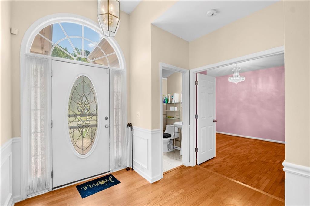 Undisclosed Address Atlanta, GA 30331 - Photo 4 of 25 a view of a hallway with entryway wooden floor and front door