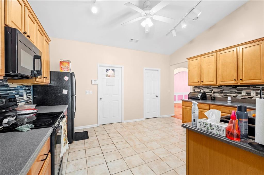 Undisclosed Address Atlanta, GA 30331 - Photo 6 of 25 a kitchen with stainless steel appliances granite countertop a stove and a refrigerator