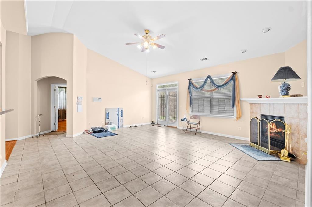Undisclosed Address Atlanta, GA 30331 - Photo 7 of 25 a view of an empty room with a fireplace and a chandelier