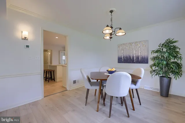 a view of a dining room with furniture wooden floor and chandelier