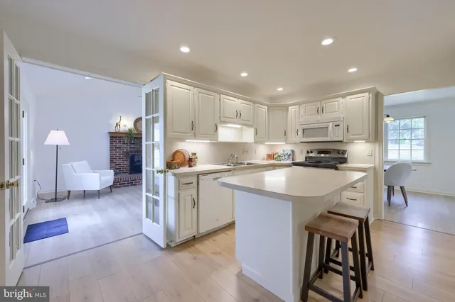 a kitchen with a sink cabinets and wooden floor