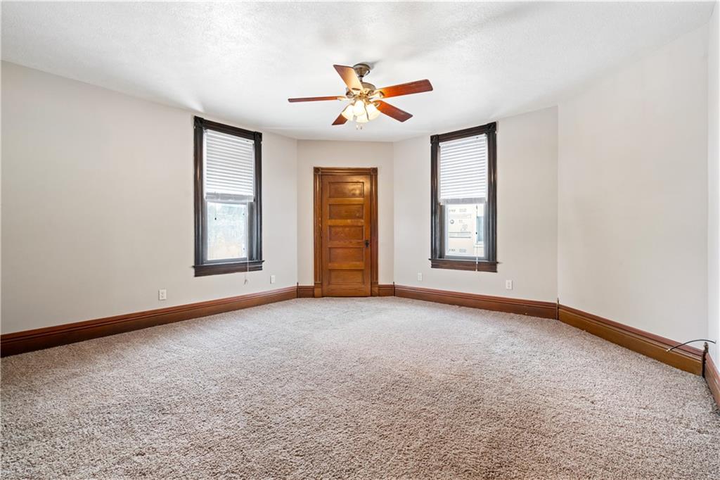 109 North Main Street Houston, PA 15342 - Photo 13 of 25 an empty room with windows and ceiling fan