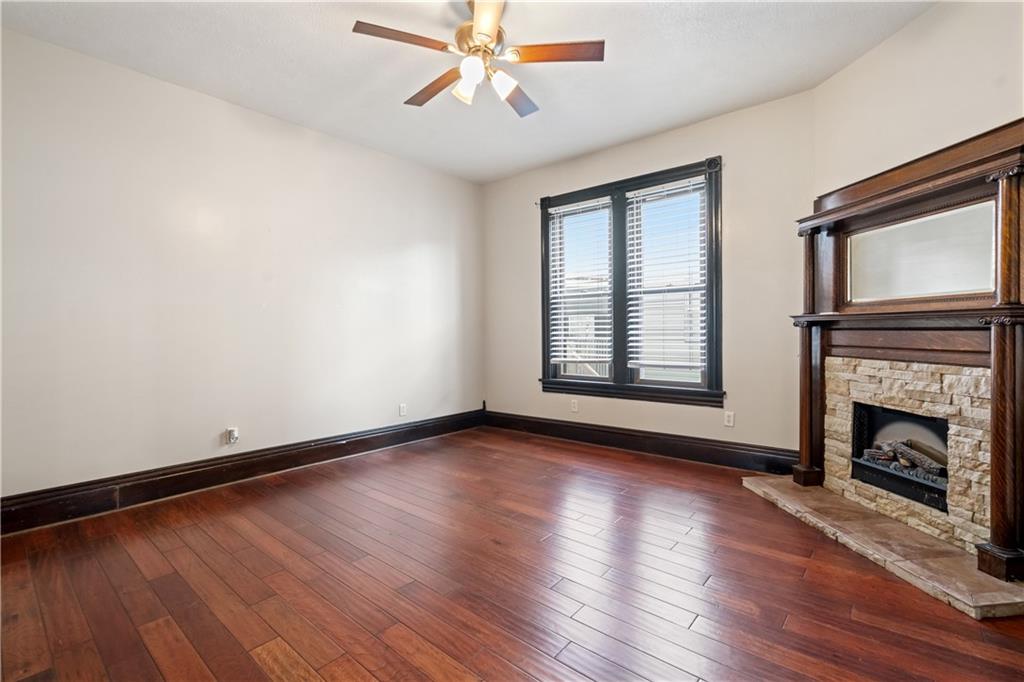 109 North Main Street Houston, PA 15342 - Photo 6 of 25 a view of an empty room with wooden floor fireplace and a window