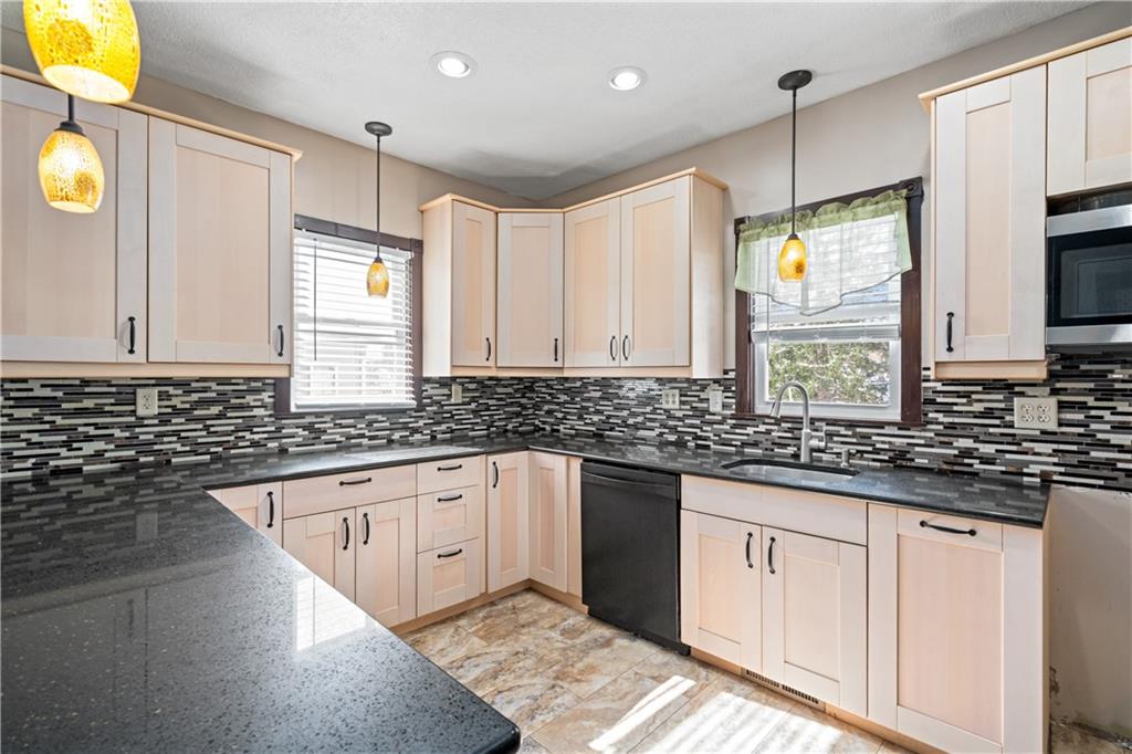 109 North Main Street Houston, PA 15342 - Photo 9 of 25 a kitchen with granite countertop a sink stainless steel appliances and cabinets