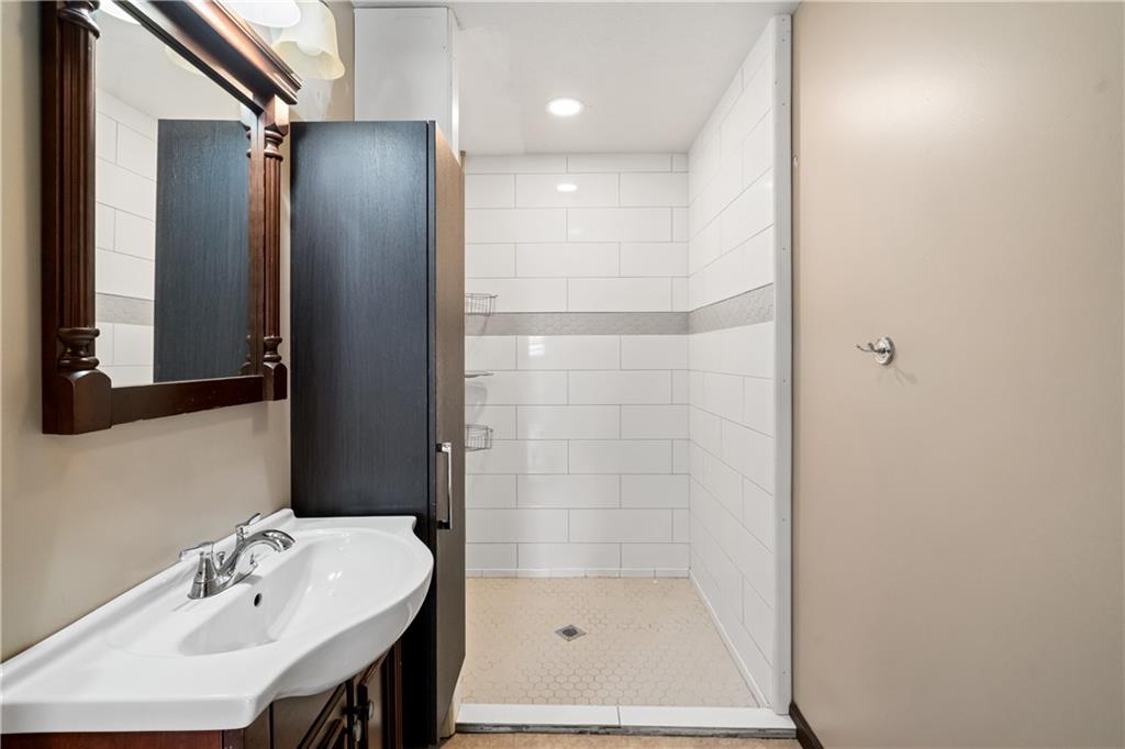 109 North Main Street Houston, PA 15342 - Photo 10 of 25 a bathroom with a shower a sink and a mirror
