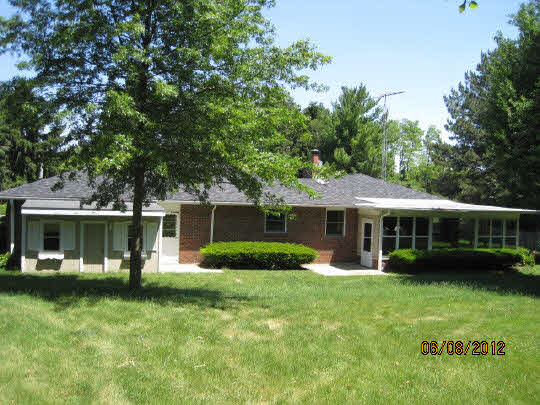 13491 East Bethel Road Rochelle, IL 61068 - Photo 2 of 11 front view of a house with a yard table and chairs