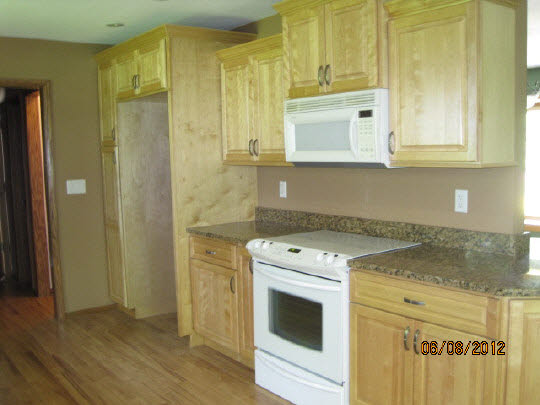 13491 East Bethel Road Rochelle, IL 61068 - Photo 5 of 11 a kitchen with granite countertop cabinets stainless steel appliances and wooden floor