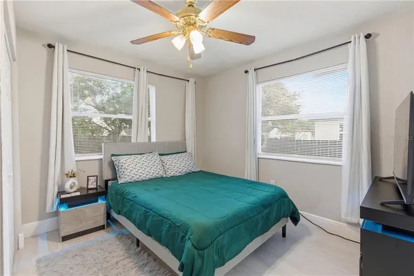 a bedroom with a large bed and a window