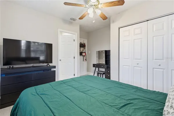 a bedroom with a bed and a flat screen tv