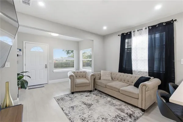 a living room with furniture and a large window