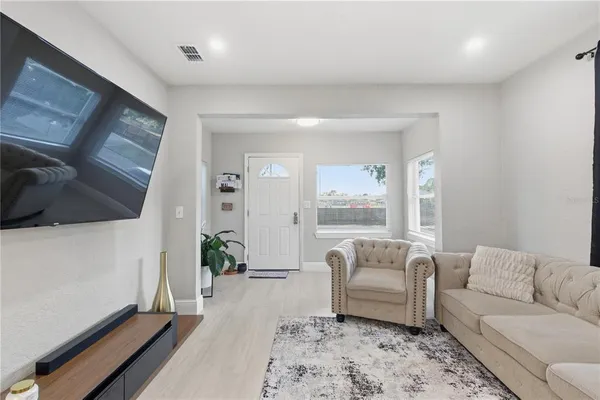 a living room with furniture and wooden floor