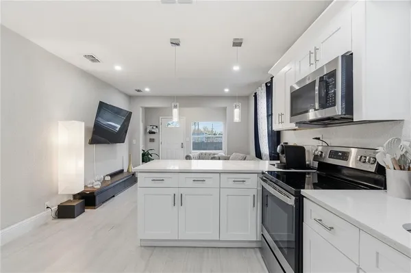 a kitchen with a sink stove and microwave