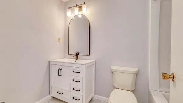 a white bath tub sitting next to a toilet