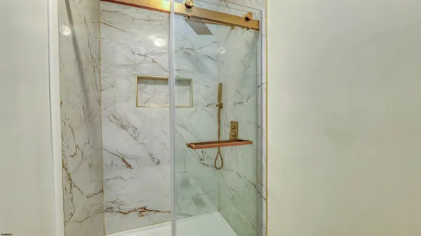 a bathroom with a glass shower door
