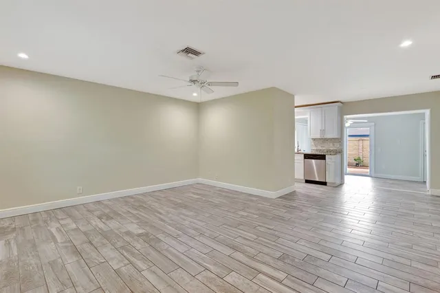 a view of a kitchen with a sink and a refrigerator