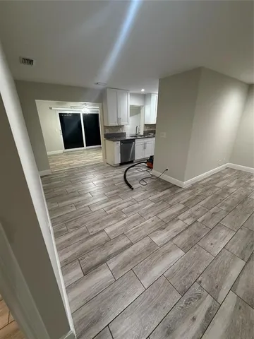 a view of a livingroom with furniture and wooden floor