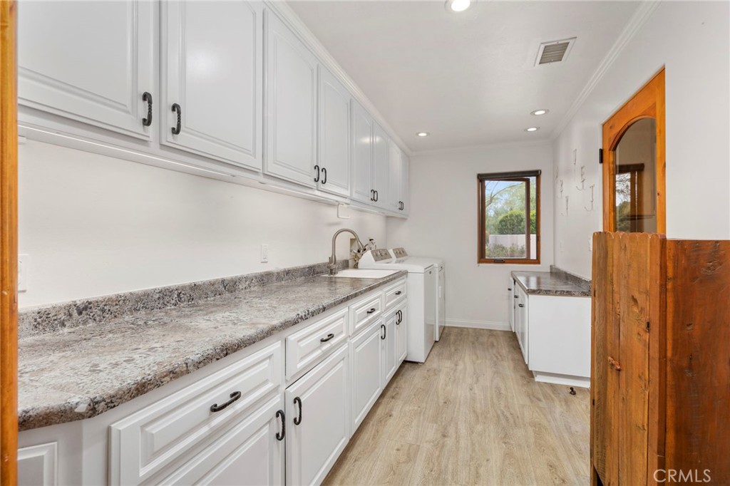 43991 John Warner Road Temecula, CA 92592 - Photo 29 of 39 a kitchen with granite countertop white cabinets and white appliances