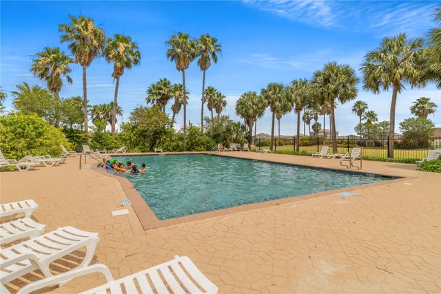 a view of a swimming pool and trees in the background