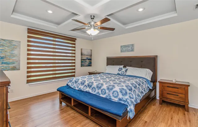 a bedroom with a bed and a chandelier