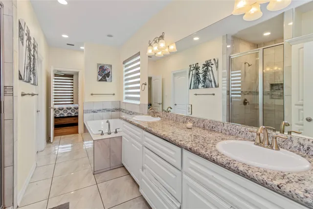 a bathroom with a granite countertop sink a toilet a mirror and shower