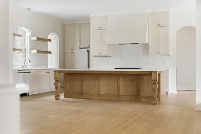 a kitchen with cabinets and a refrigerator