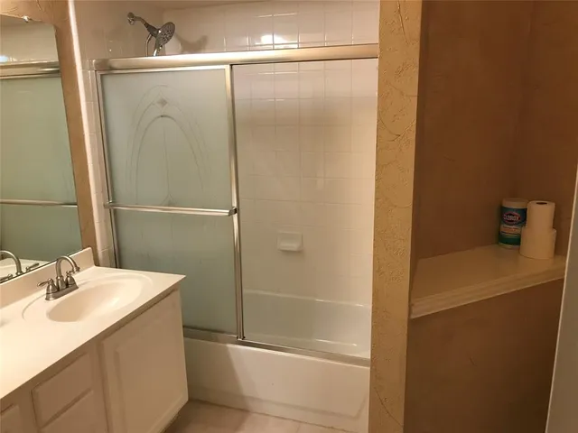 a bathroom with a sink a mirror and shower