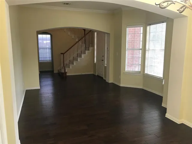 a view of a livingroom with wooden floor and a window
