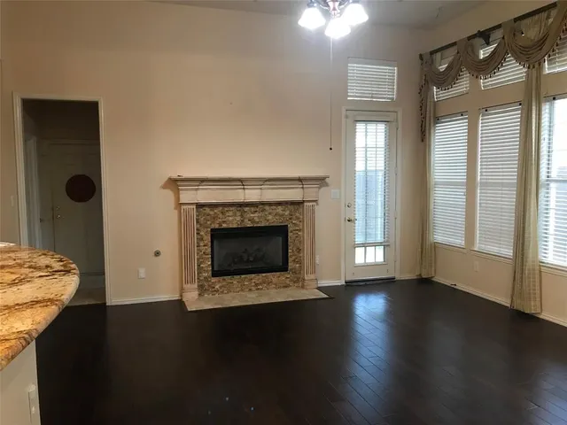 a living room with hard wood floors and a fireplace