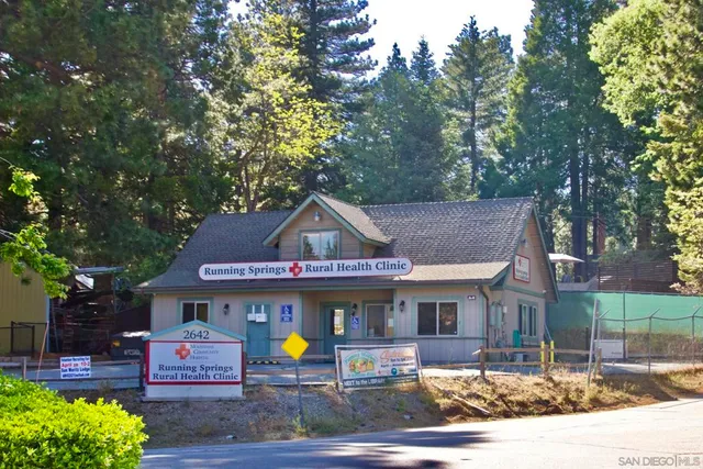 a front view of a house with a yard and a garage