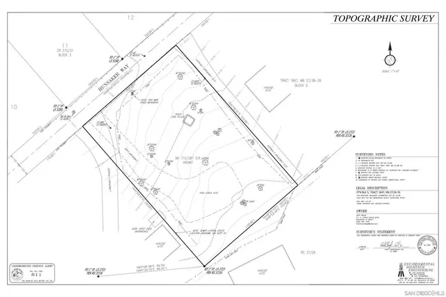 a white building with a yard and deck