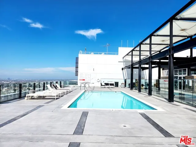 a living room with furniture a rug and white walls