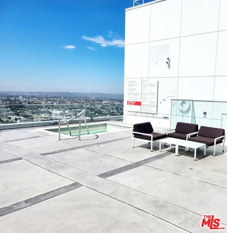 a view of a living room with furniture and floor to ceiling window
