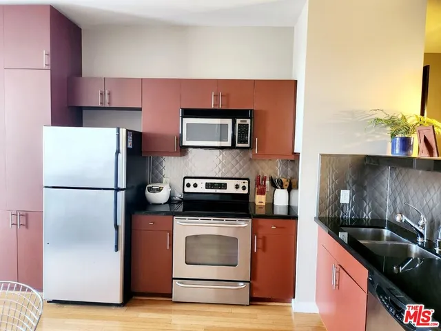 a kitchen with a refrigerator and a stove
