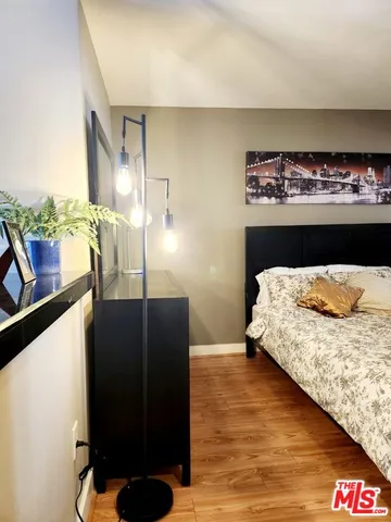 a view of a swimming pool with lawn chairs and couches