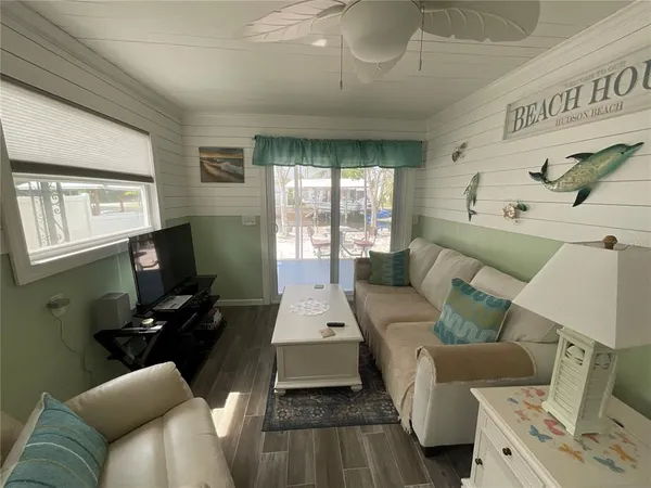 a living room with furniture and a flat screen tv